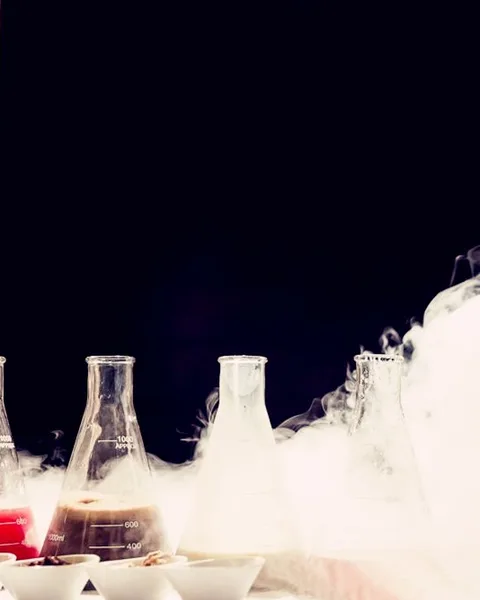 Flasks of gelato base on the bar, nitrogen fog rolling past them